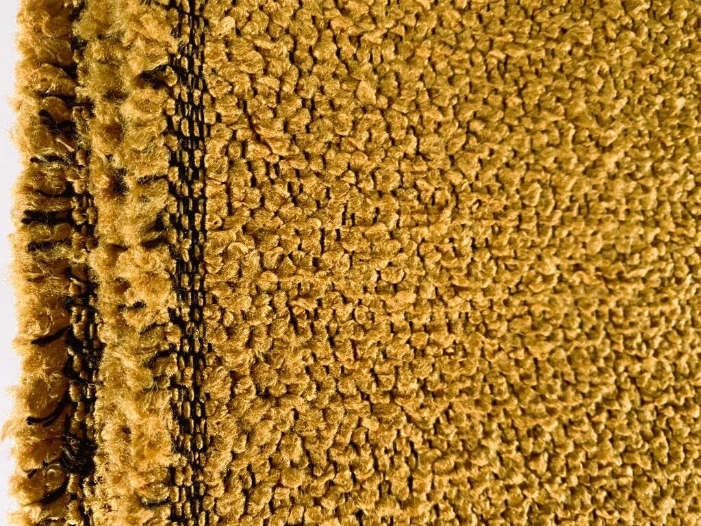 meubelstof bouclé oranje geel