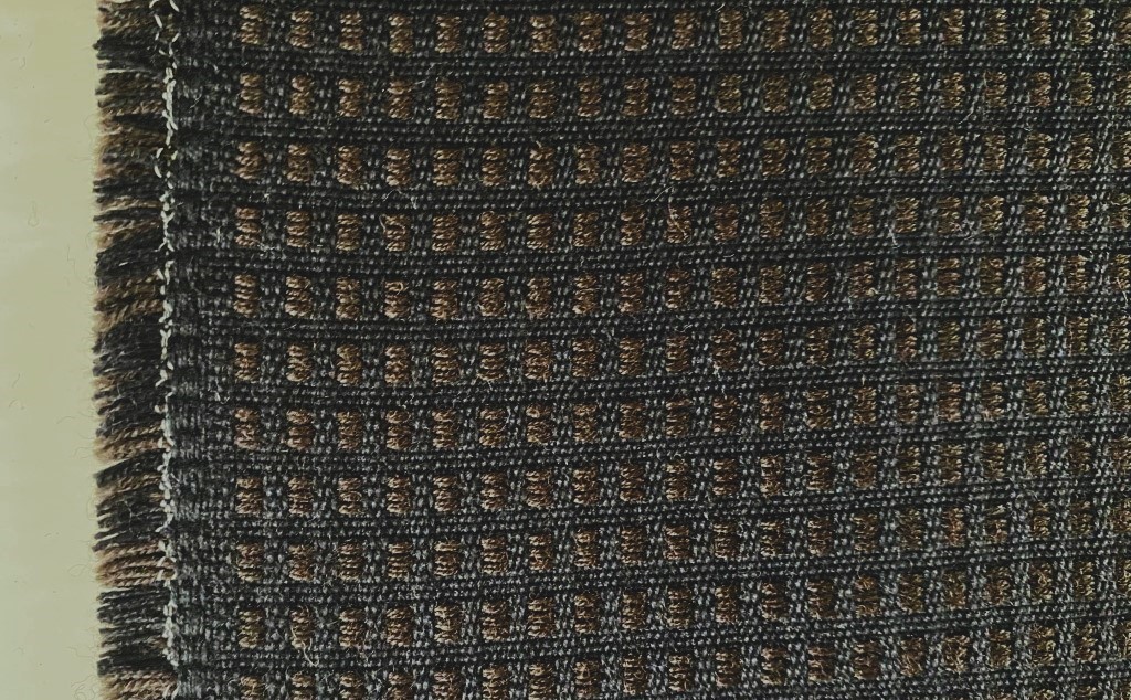 De Ploeg bruin zwart geblokt patroon