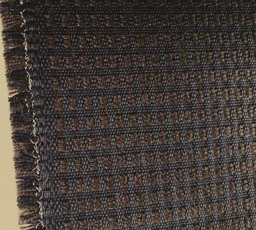 De Ploeg bruin zwart geblokt patroon